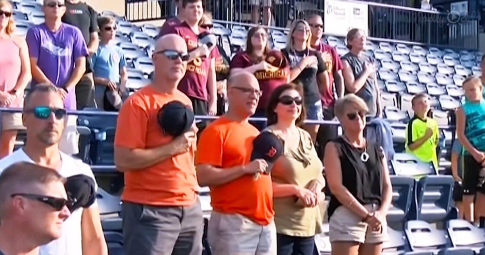 baseball fans had their fist over their hearts when 96-year-old WWII vet sings National Anthem