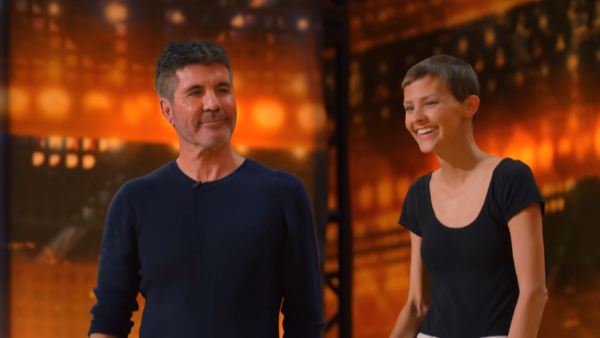 Simon Cowell smiling while looking at Nightbirde moments after her Golden Buzzer win.
