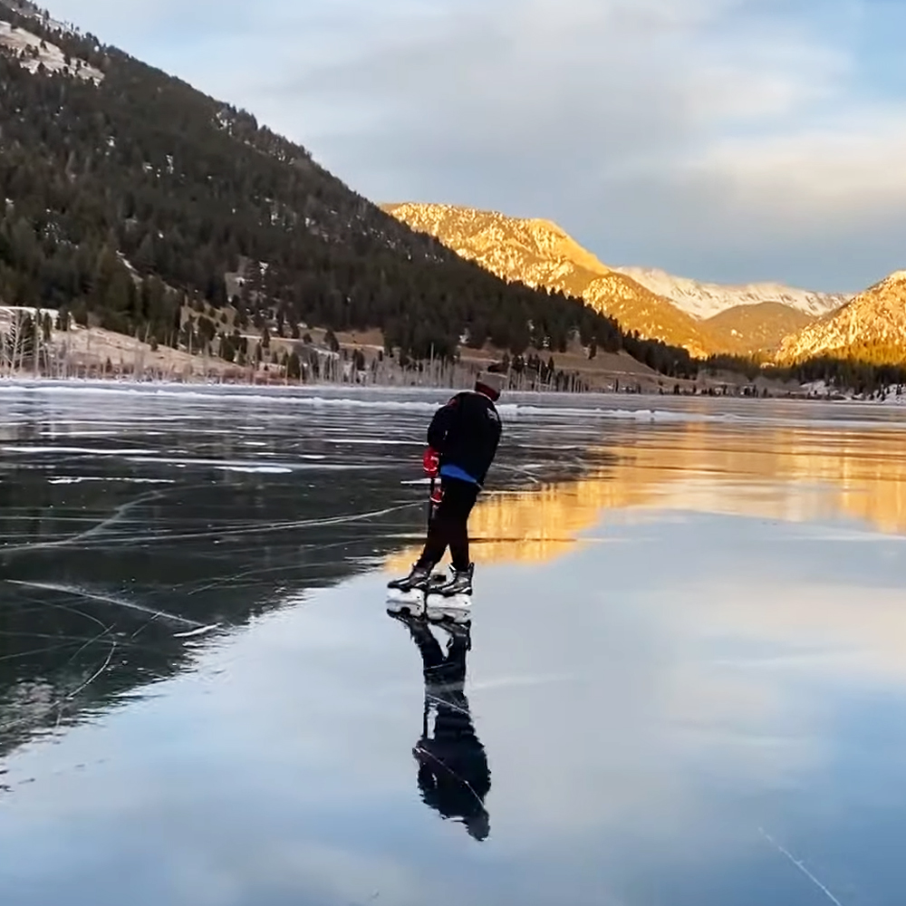 Kids practicing hockey on a frozen Lake